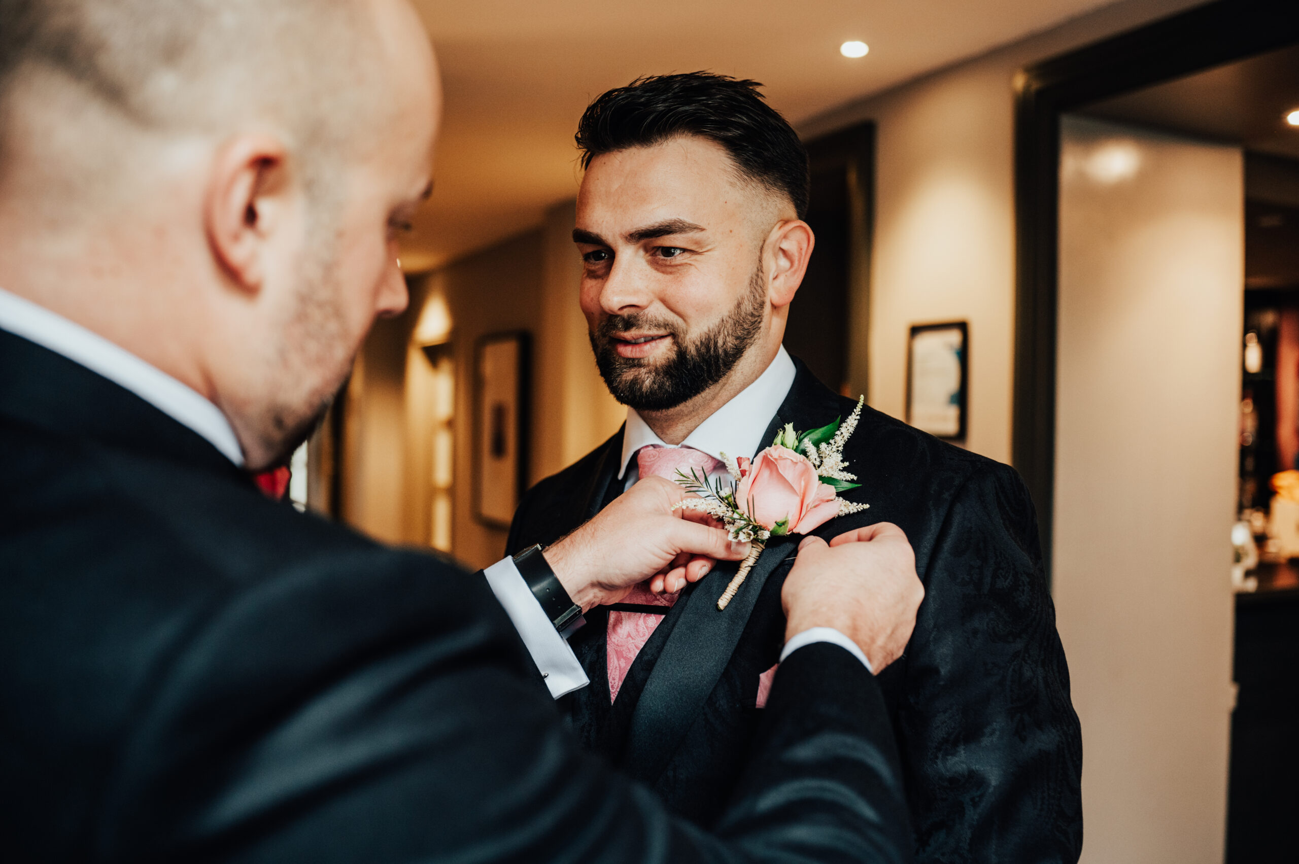 Jamie having a flower put on his bespoke custom tailred suit
